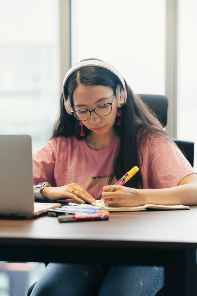 young-woman-wearing-headphones-studying-at-a-desk-mrteiaj9uam